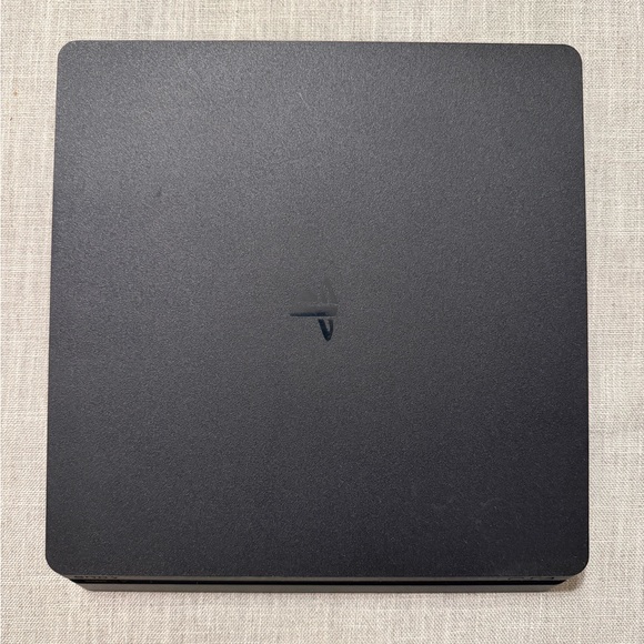 Sony PlayStation 4 (PS4) with controllers